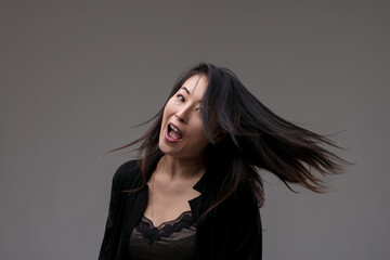 Hair swirls as laughter captures joyful essence