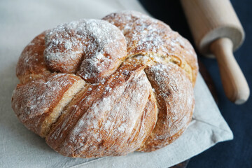 Fresh bread on a linen towel on a dark background