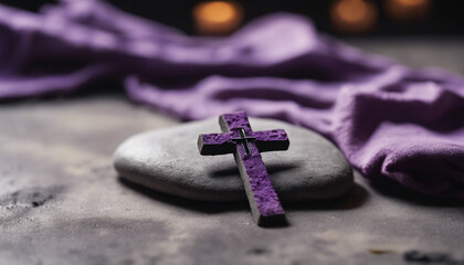 Ash Wednesday concept with a cross of ashes on a stone surface, purple cloth in the background