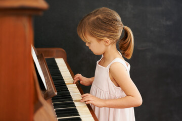 Piano, playing and kid in home for learning, practice and classical education with musical notes....