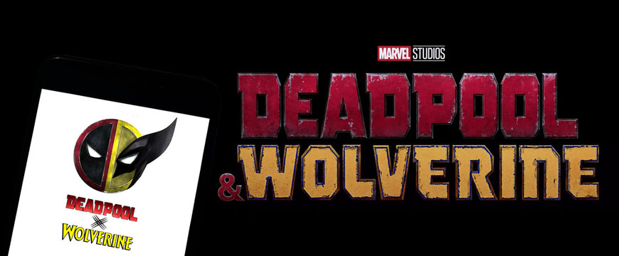 Logo of Deadpool & Wolverine movie on phone screen with official movie logo on the background on TV screen.