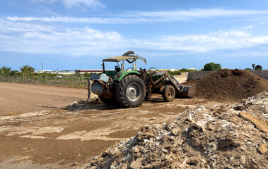 Obraz premium Farmer tractor on the farm. Agricultural tractor on the farmer field. Spain olive farm
