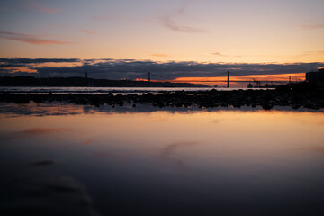 Sunset on Tagus river in Lisbon. View on Bridge
