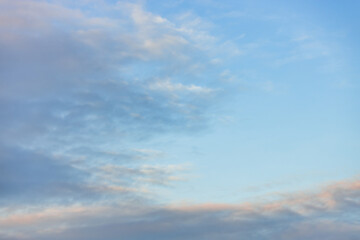 A beautiful sky tinted by the sun leaving vibrant shades of gold, pink, blue and multicolored. Clouds in the twilight evening and morning sky. Cloudy sky background in the evening and during the day.