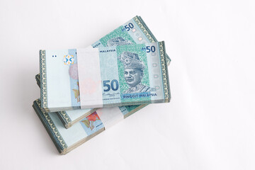 Malaysia Currency Ringgit 50: Stack of Ringgit Malaysia bank note on white background. Selective focus and top view.