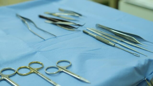 Medical instruments lie on a sterile table. Close-up