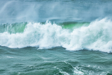 Wave splashing close-up. Crystal clear sea water, in the ocean in San Francisco Bay, blue water, pastel colors.