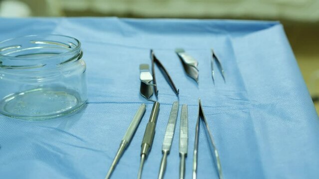 Various medical tweezers on a sterile table in the operating room.