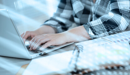 Female hands using laptop; light effect