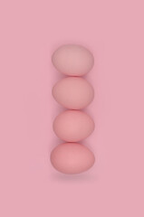 Eggs tower, pink eggs and pink background - monochromatic photo, abstraction. 