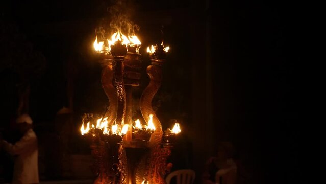 High definition slow motion footage of a traditional fire chandelier at a Balinese temple ceremony, Bali, Indonesia.
Medium angle, parallax movement.