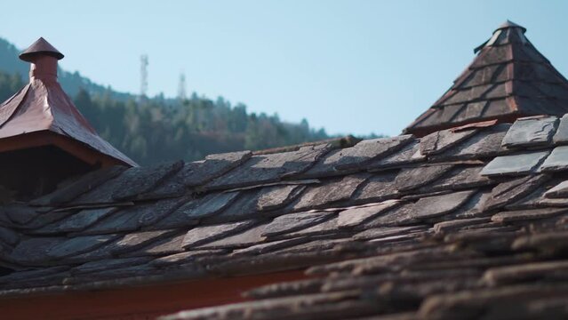 Closeup shot of traditional roof the old wooden houses of Himachal with slate tiles on top of them at Manali in Himachal Pradesh, India. Old traditional roof of the old homes of Himachali culture.