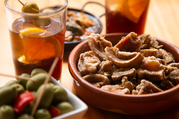 Table with Spanish tapas and vermouth at noon in a bar in Barcelona.