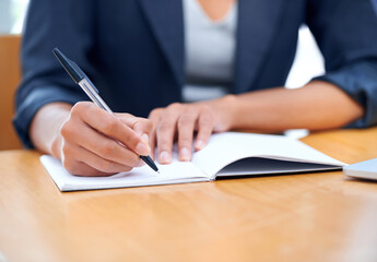 Hands, business and writing in book closeup, agenda and information in office. Journal, notes and fingers of professional secretary at desk with pen for reminder, schedule and planning project ideas