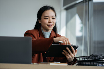Young business wiman using computer working online, doing searching, taking notes, watching business training webinar in office, having virtual chat meeting looking at laptop at work.