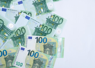 100 Euro banknotes in a row and space for copy text. European Union Currency. Stack of 100 euro banknotes.