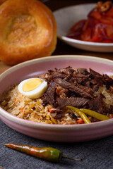 pilaf with meat, tomato salad and bread