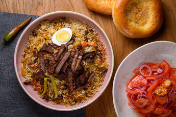 pilaf with meat, tomato salad and bread