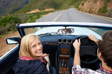 Couple, driving and convertible steering wheel on mountain from behind for vacation happy,...