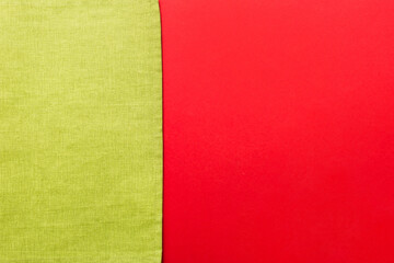Obraz premium top view with green kitchen napkin isolated on table background. Folded cloth for mockup with copy space, Flat lay. Minimal style