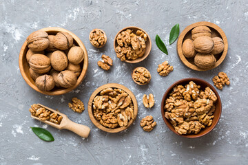 Walnut kernel halves, in a wooden bowl. Close-up, from above on colored background. Healthy eating Walnut concept. Super foods with copy space