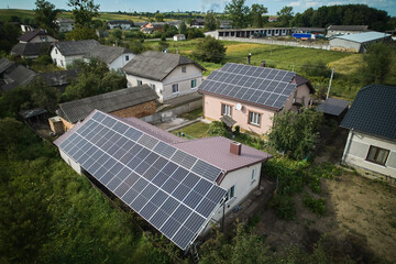Aerial top view of new modern house cottage with solar photovoltaic panel system on house roof