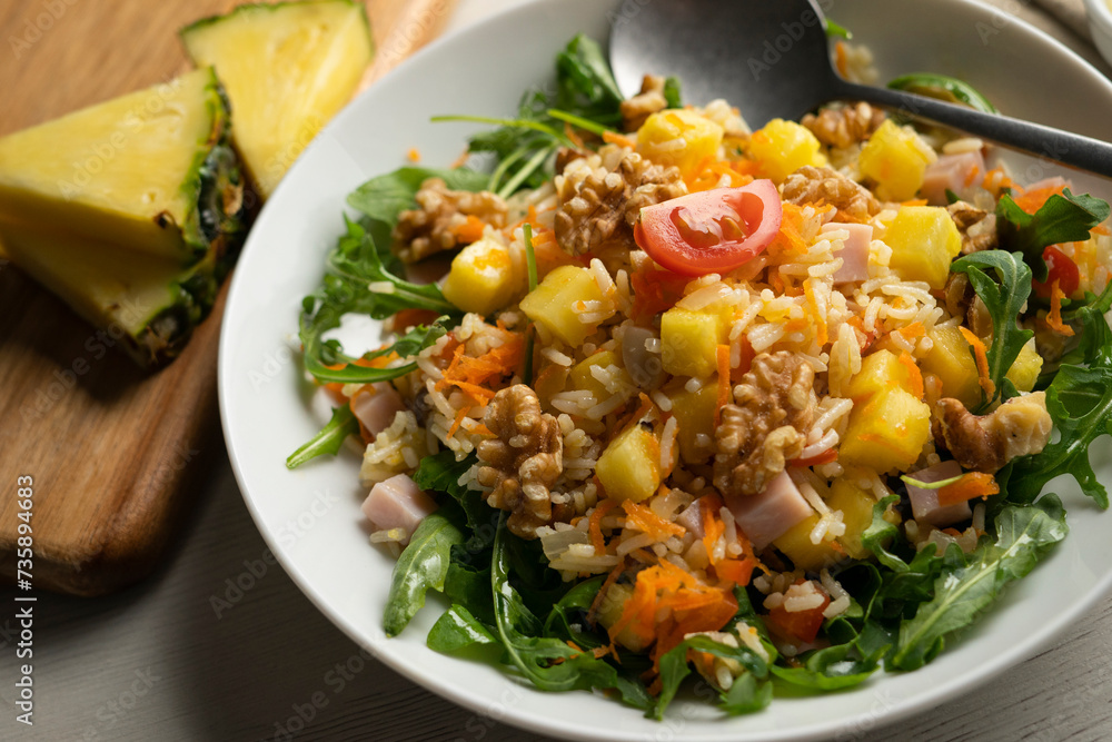 Wall mural rice salad with pineapple, walnuts and arugula.