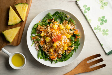Rice salad with pineapple, walnuts and arugula.