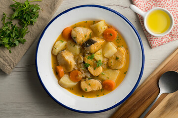 Hake stew with potatoes and carrots. Traditional Spanish recipe.