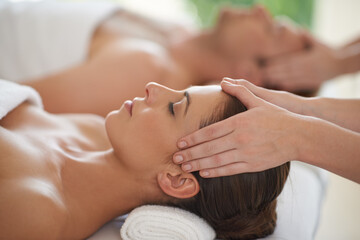 Obraz na płótnie Canvas Massage, head and couple in spa to relax with luxury treatment for wellness on holiday or vacation. Beauty, care and calm people together in hotel, salon or resort for healthy facial or skincare