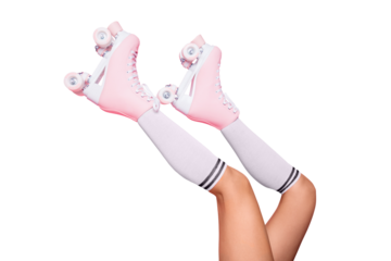 Close up crop photo of  legs in vintage quad roller skates shoes isolated on pink background