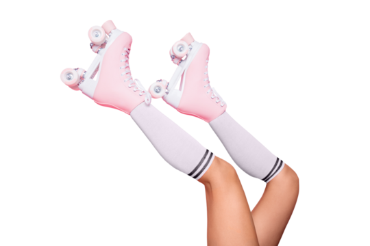 Close up crop photo of  legs in vintage quad roller skates shoes isolated on pink background