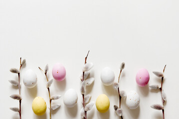 Easter composition with a willow branch and quail eggs on a light gray background. Springtime and...