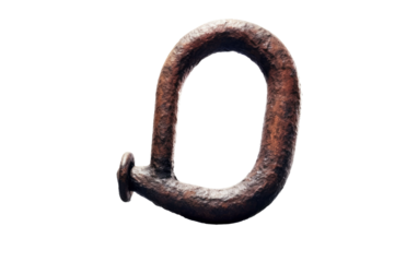 The Letter Q Is Made Up of Metal. A close up photograph of a metal sculpture shaped like the letter Q.