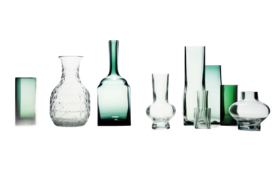 Group of Glass Vases Arranged Together. A collection of glass vases, varying in size and shape, placed side by side on a flat surface.
