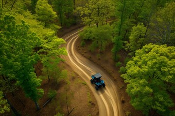 aerial view of an atv on a winding forest trail