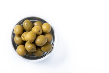 Green olives in white bowl isolated on white background. Top view. Copy space
