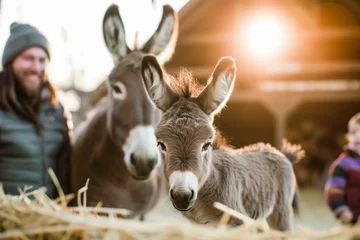 Tuinposter family watching newborn donkey stand for the first time © primopiano