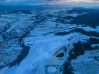 Lot nad Tyliczem o zachodzie słońca zimą. Zimowy krajobraz.