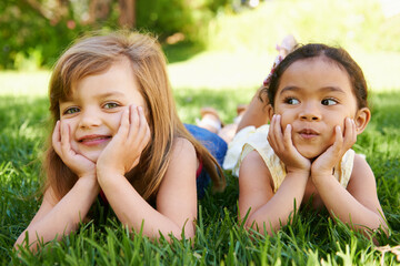 Smile, nature and portrait of children on grass playing together in outdoor park or garden on...