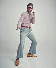 70s, fashion and portrait of man with retro or vintage aesthetic in gray background of studio....
