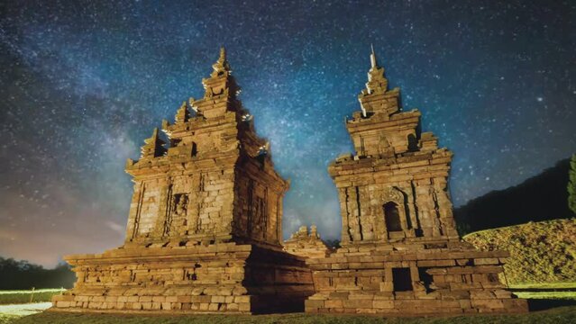 Gedongsongo Temple at night with starry sky and milky way galaxy. Seamless looping 4k video. 