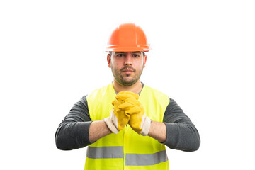 Serious male builder wearing work safety equipment with gloves