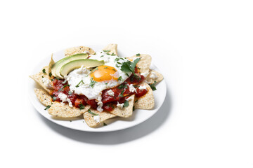 Traditional Mexican breakfast red chilaquiles with egg isolated on white background. Copy space