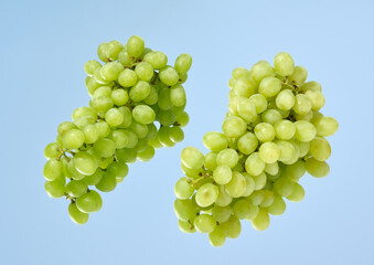 Ripe, juicy green grapes on the mirror. Proper fruit and berry dessert.