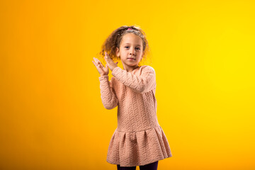 Kid girl clapping and applauding happy and joyful, smiling proud hands together