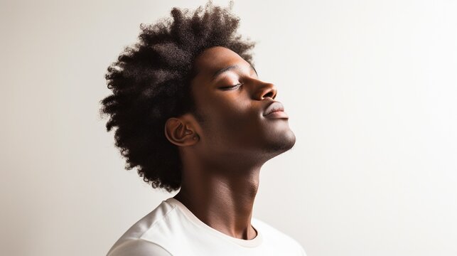 Young Man's Textured Afro Shines Against White Background