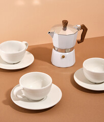 Moka coffee pot for making deliciously aromatic coffee and beautiful table setting with ceramic tableware.