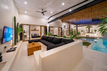 Fototapeta premium beautiful modern house in cement, interiors, view from the living room. Luxury tropical villa in Bali