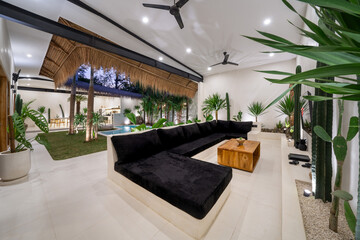 Fototapeta premium beautiful modern house in cement, interiors, view from the living room. Luxury tropical villa in Bali